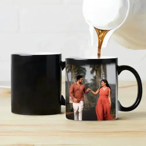 Black magic mug revealing colorful hidden design with hot beverage