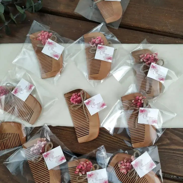 Handcrafted wooden baby comb with dried flowers and personalized tag