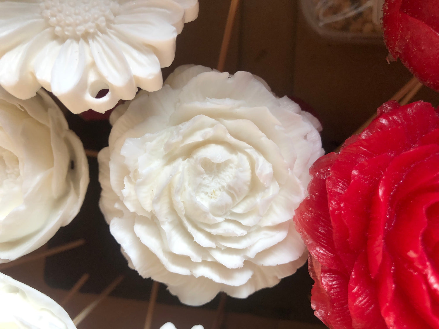 Handcrafted decorative perfume soaps with elegant rose designs and vibrant colors for luxury home décor.