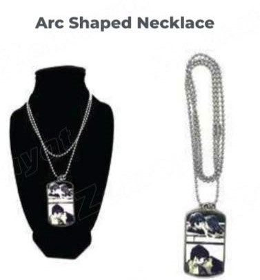 Silver-tone arc-shaped necklace with rectangular photo pendant shown beside a black necklace display
