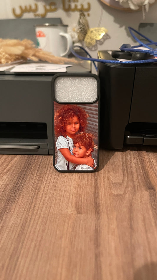 Phone case with a design of two children on a wooden desk