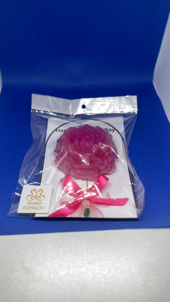 Pink flower-shaped object in a clear plastic bag with a blue background
