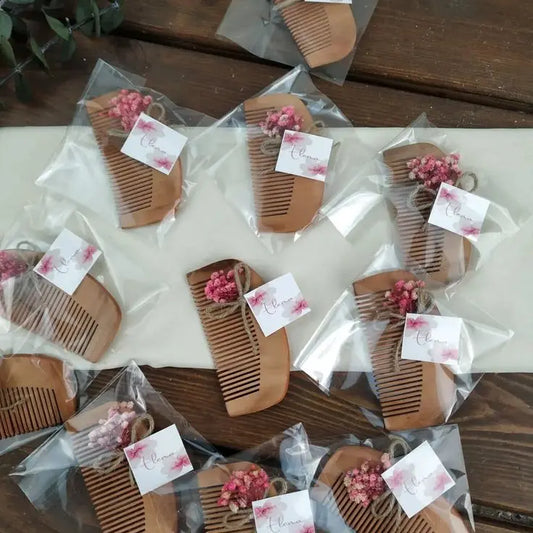 Handcrafted wooden baby comb with dried flowers and personalized tag