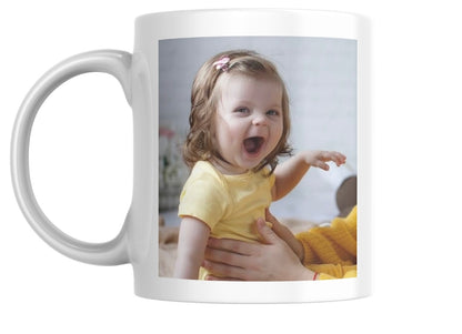 White mug with a photo of a child on it